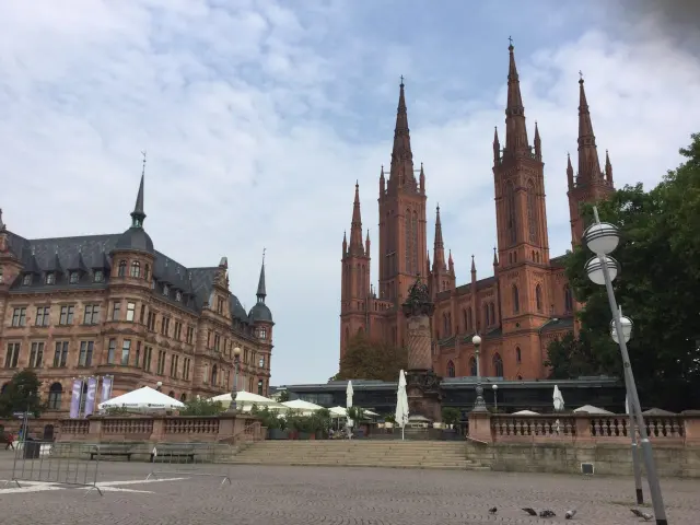 A red stone church beside a city square