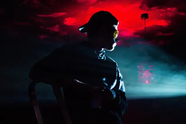 Alexey performing under red and blue stage light