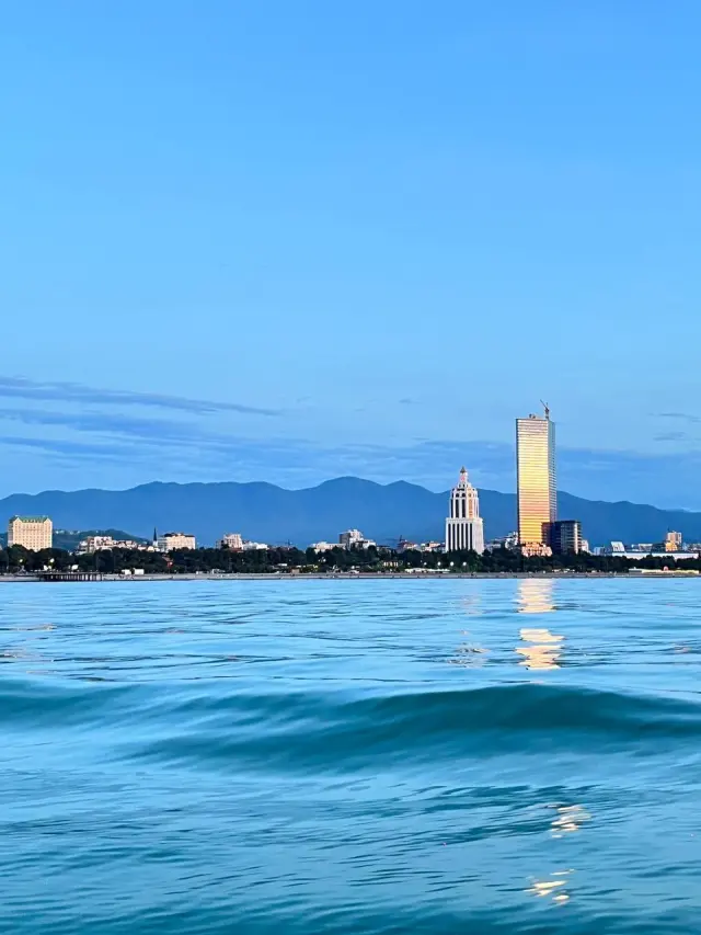 City towers across blue water