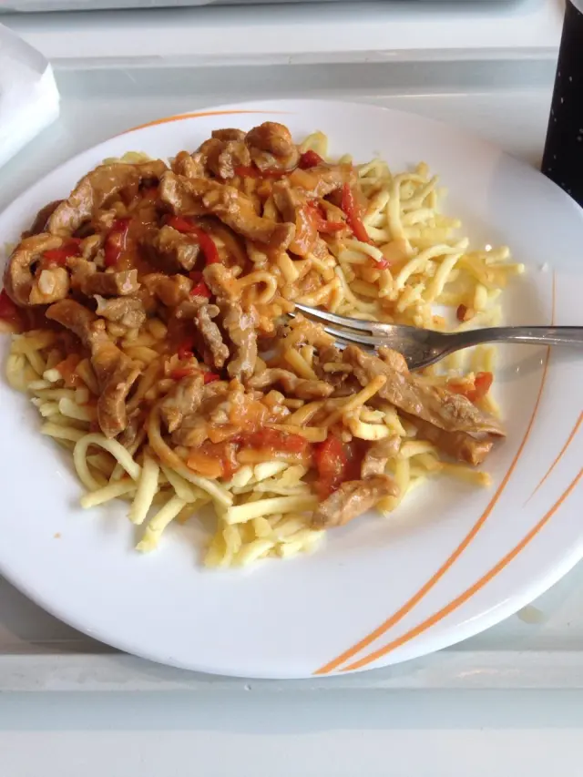 A plate of pasta by a window