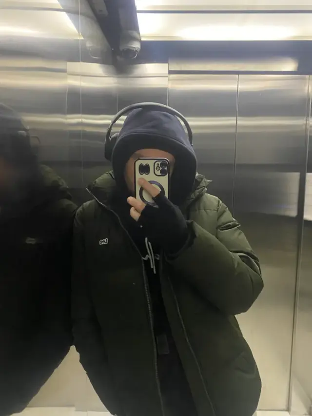 Alexey taking a mirror portrait in an elevator