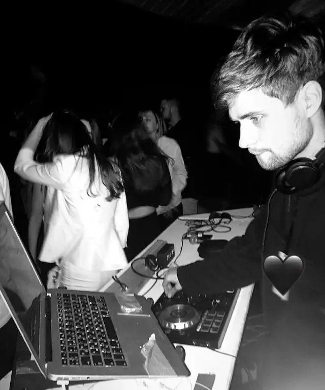 Alexey DJing in a black-and-white photograph