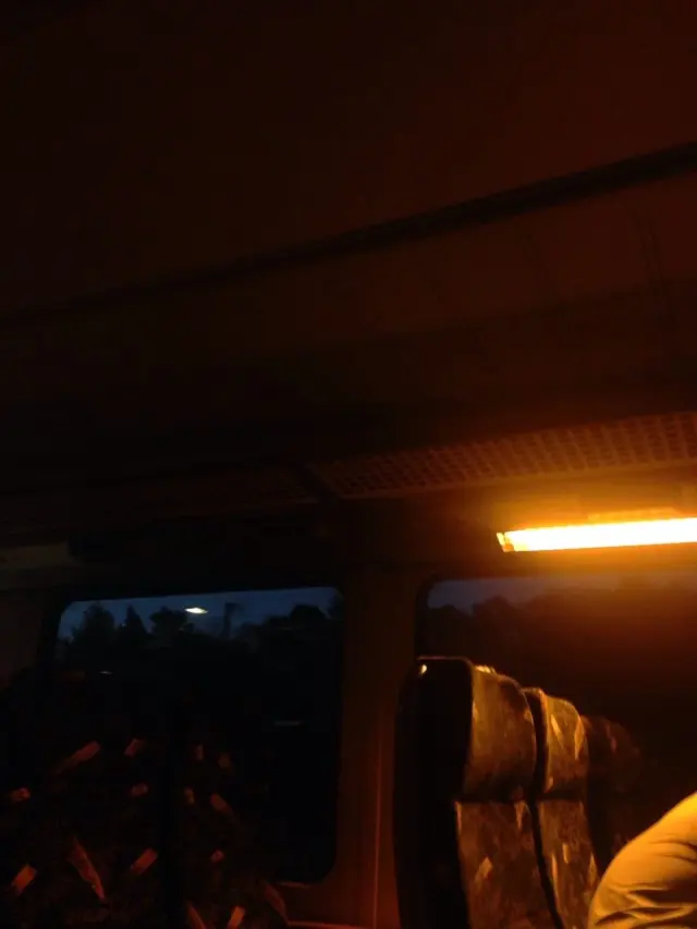 Warm light inside a train at dusk