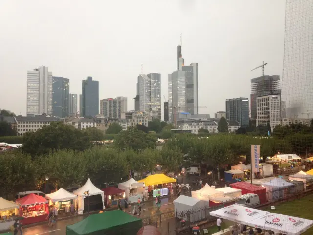 A city skyline above a market with colourful stalls