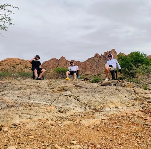 Friends walking across rocky ground