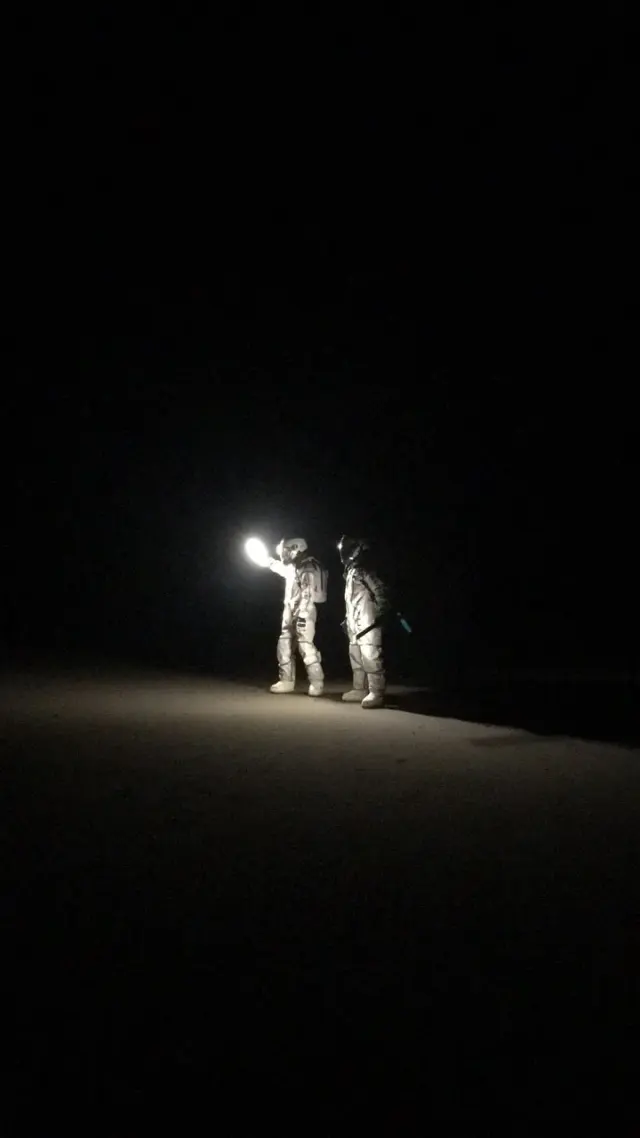 Two figures illuminated against the night